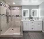 Walk-in shower with dual vanities & make up mirrors